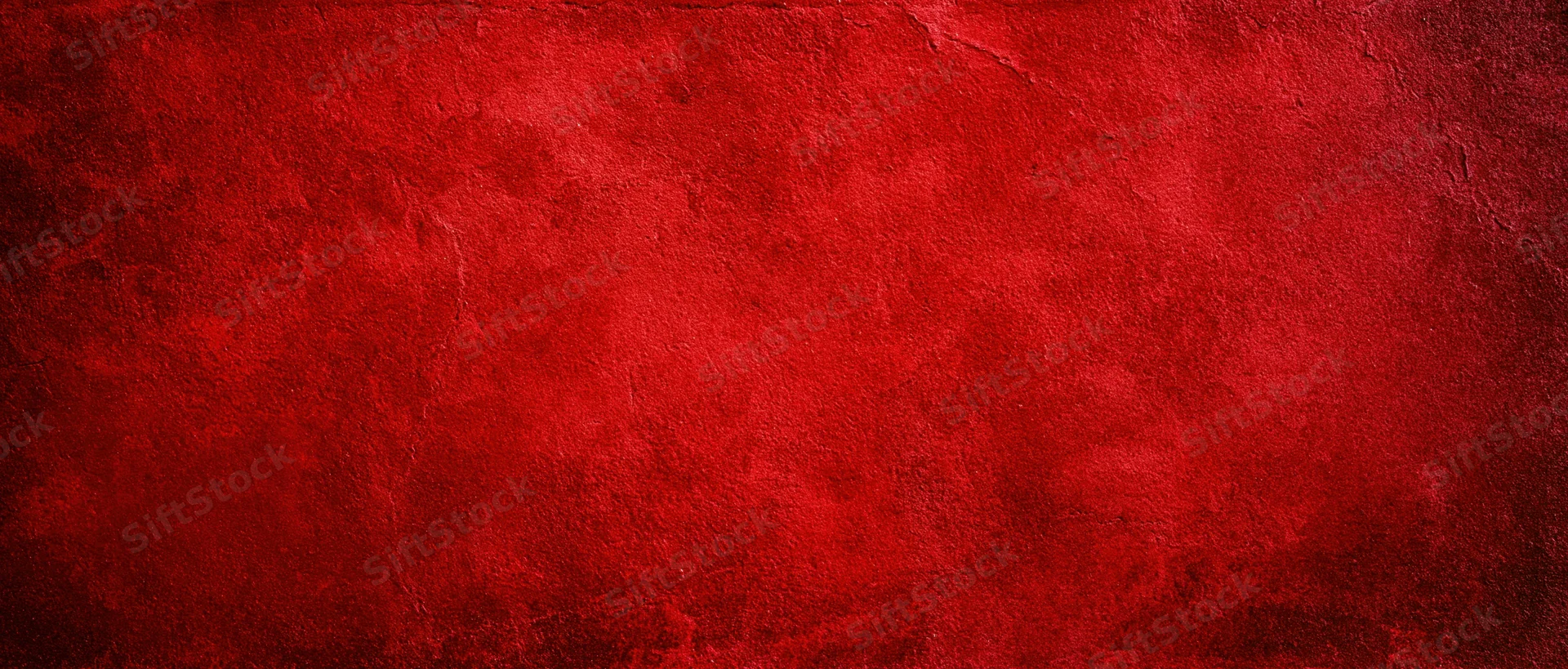 Textured red surface with grunge finish and subtle cracks as background