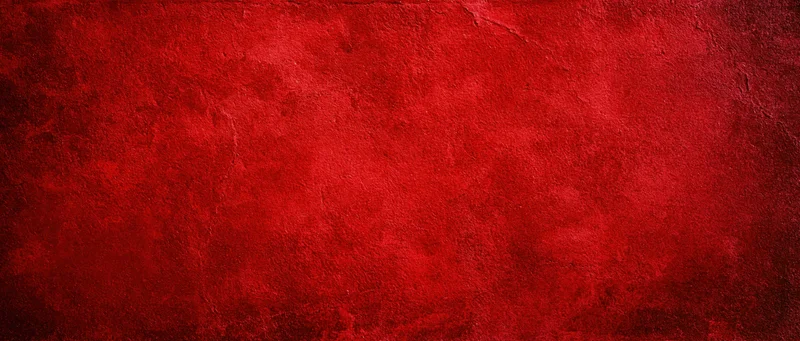 Textured red surface with grunge finish and subtle cracks as background