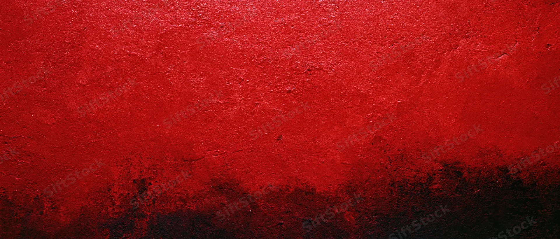 Abstract red and black textured paint on a wall surface