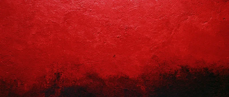 Abstract red and black textured paint on a wall surface