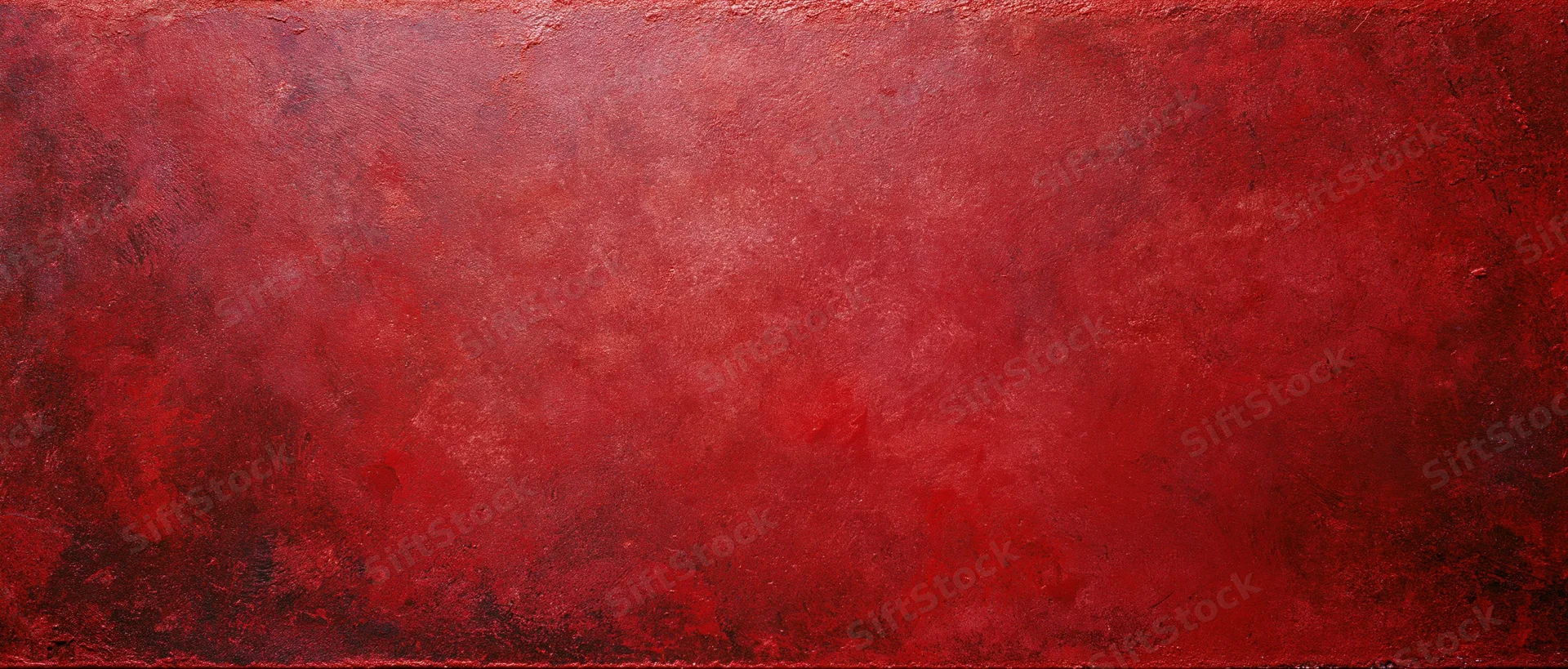 Textured red painted surface with abstract grunge finish as background