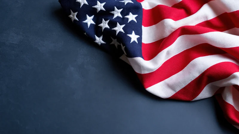 American flag draped on dark surface with copyspace