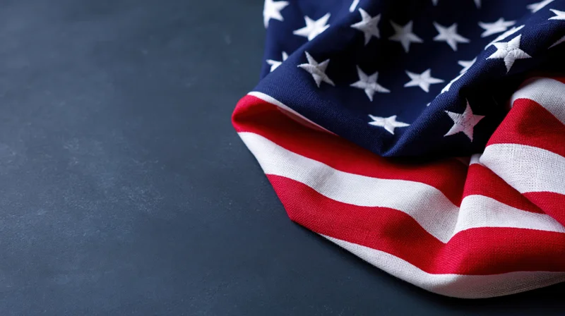 American flag draped on dark surface with copyspace