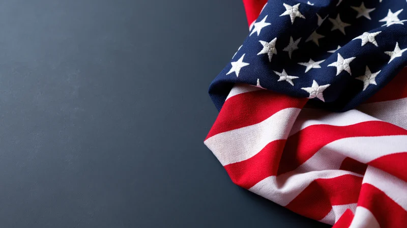 American flag draped on dark surface with copyspace
