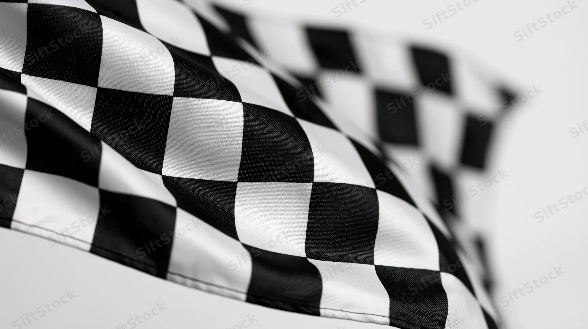 Checkered flag waving in the wind against a plain white background