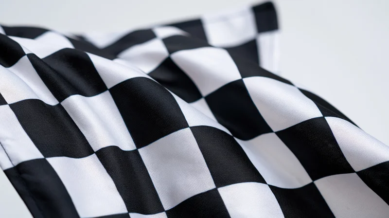 Checkered flag waving against a white background