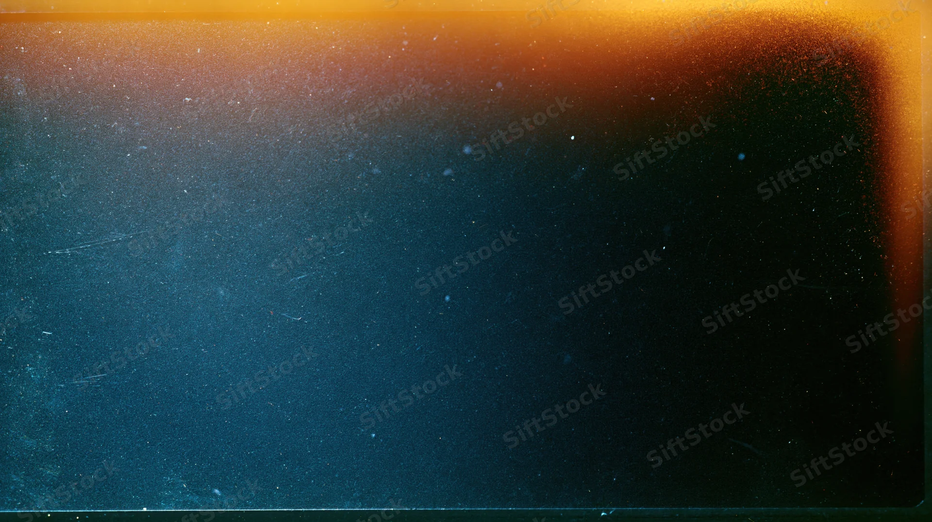 Abstract gradient transitioning from orange to dark blue with visible film grain and surface imperfections