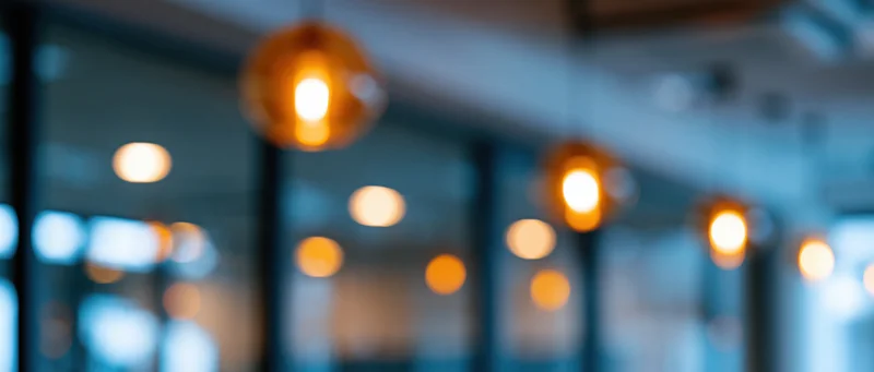 Blurred interior lights hanging from ceiling in modern office space