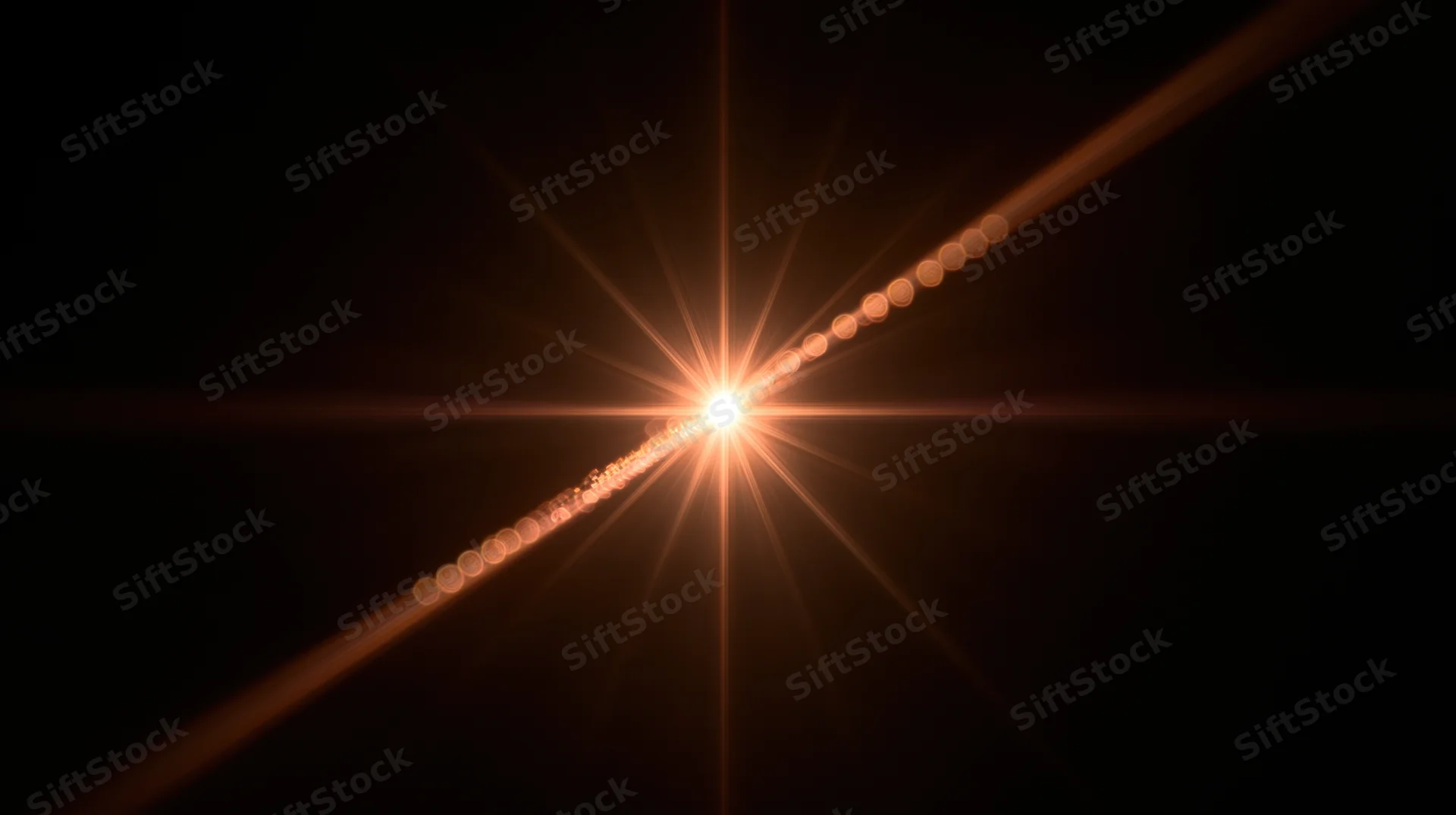 Bright starburst light flare with diagonal line of glowing circles on dark background