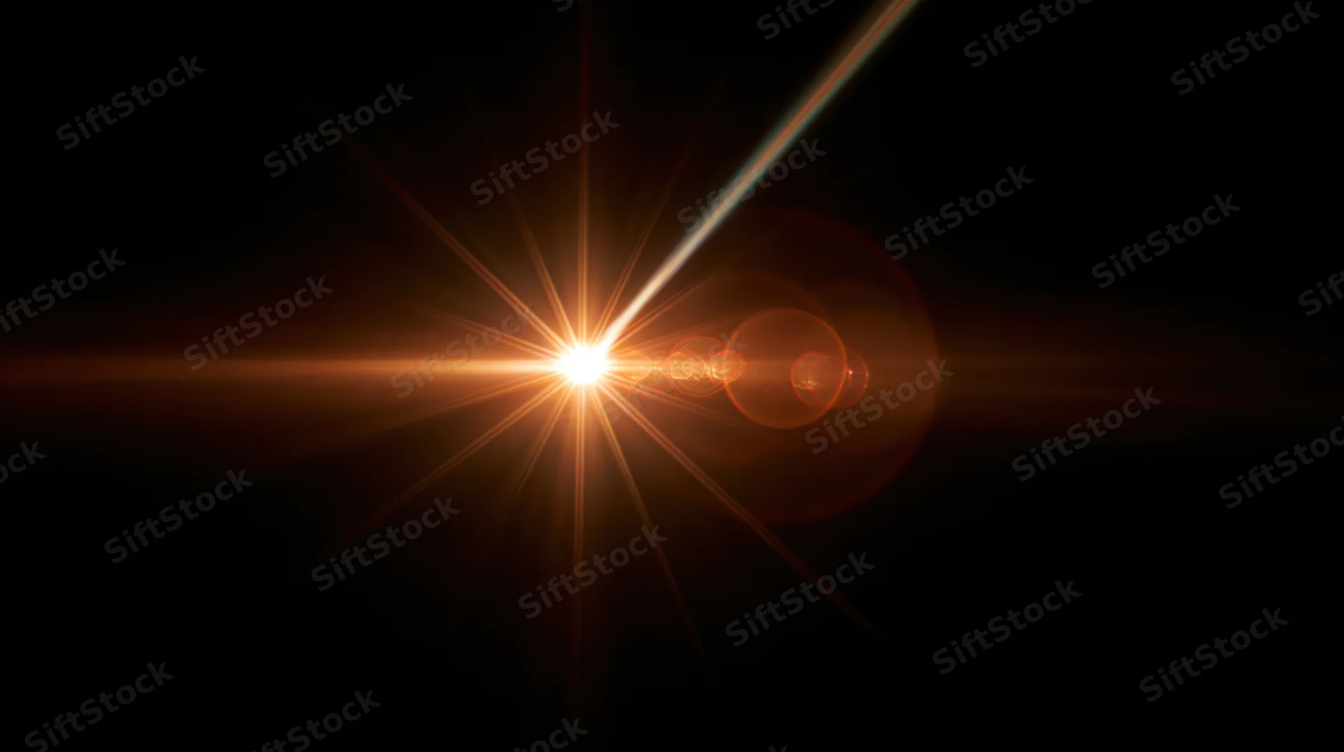 Bright orange light burst with lens flare and starburst effect on dark background