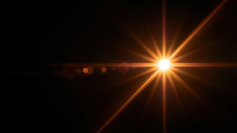 Bright orange starburst light flare on dark background with bokeh circles and horizontal glow