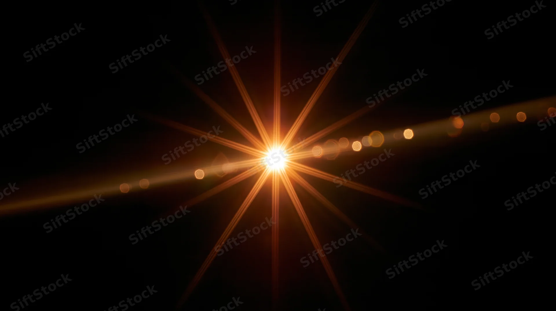 Bright golden light burst with lens flare and bokeh against dark background
