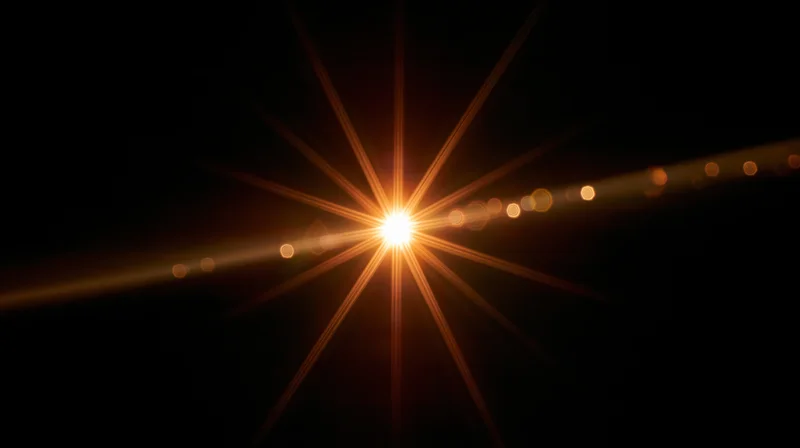 Bright golden light burst with lens flare and bokeh against dark background