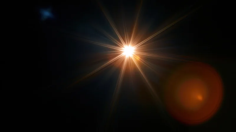 Bright star emitting radiant light beams in dark space with lens flare and bokeh effect