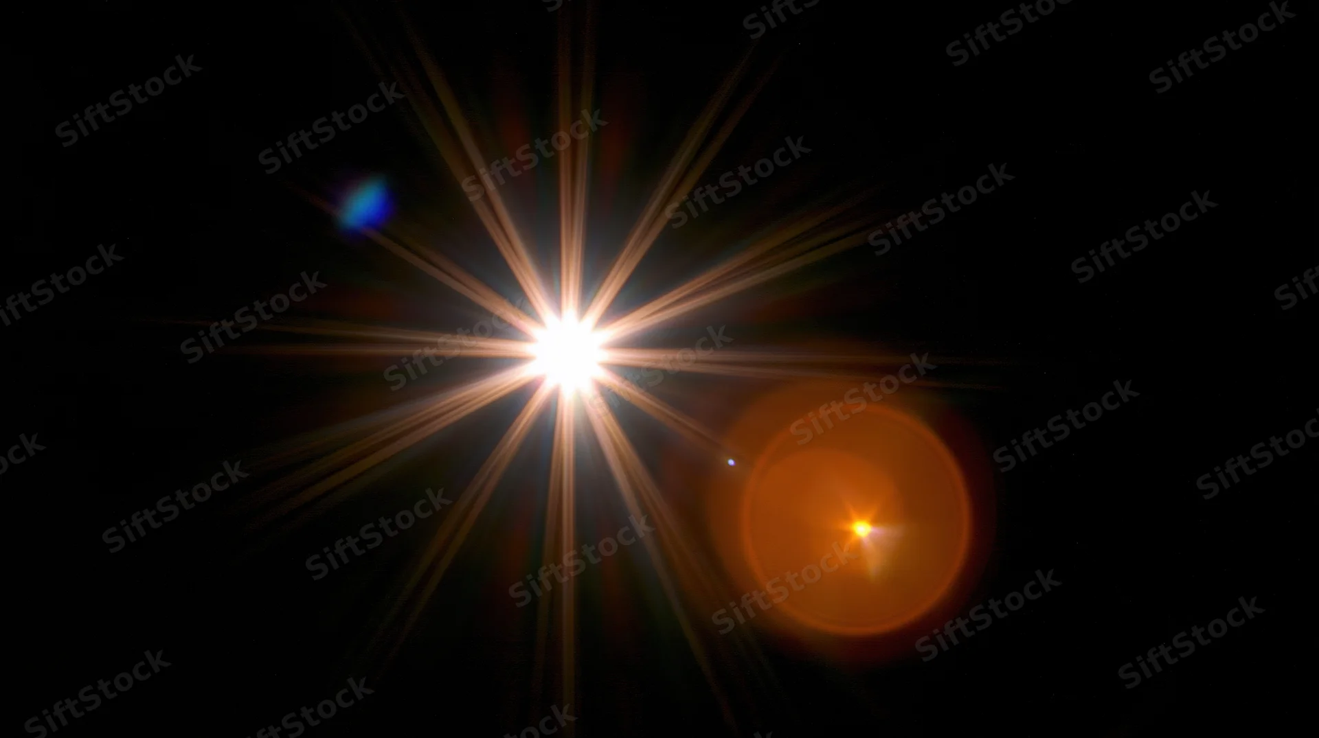 Bright star with lens flare and orange halo in dark space