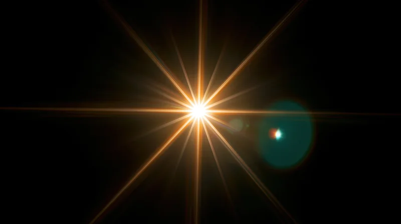 Bright starburst light effect with lens flare and bokeh in dark background