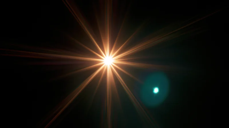 Bright starburst light radiating from center against dark background with teal bokeh spot to the side