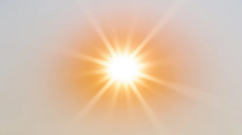 Bright sunburst radiating light against a soft gradient background