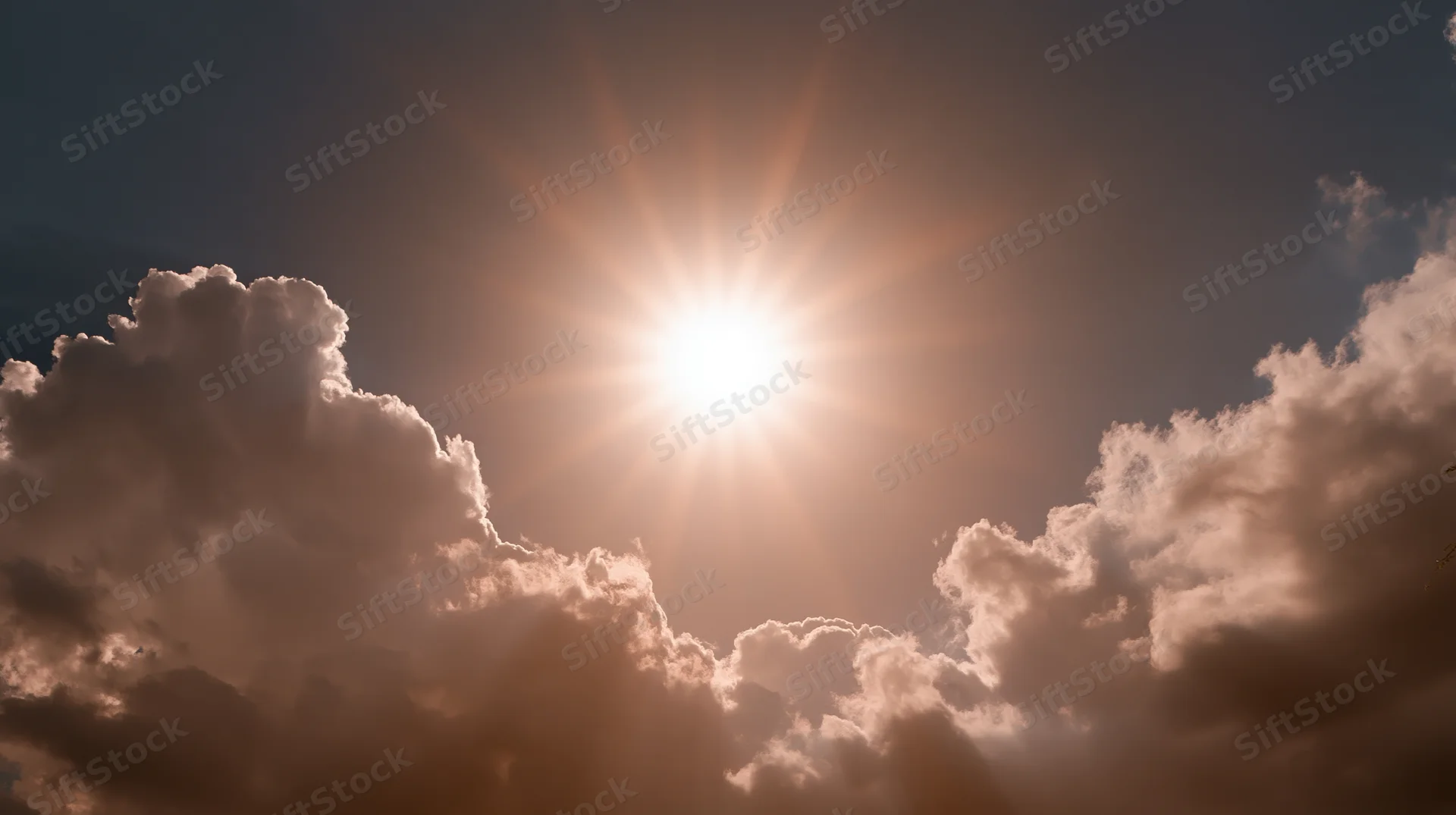 Bright sun shining through fluffy clouds in the sky during daytime