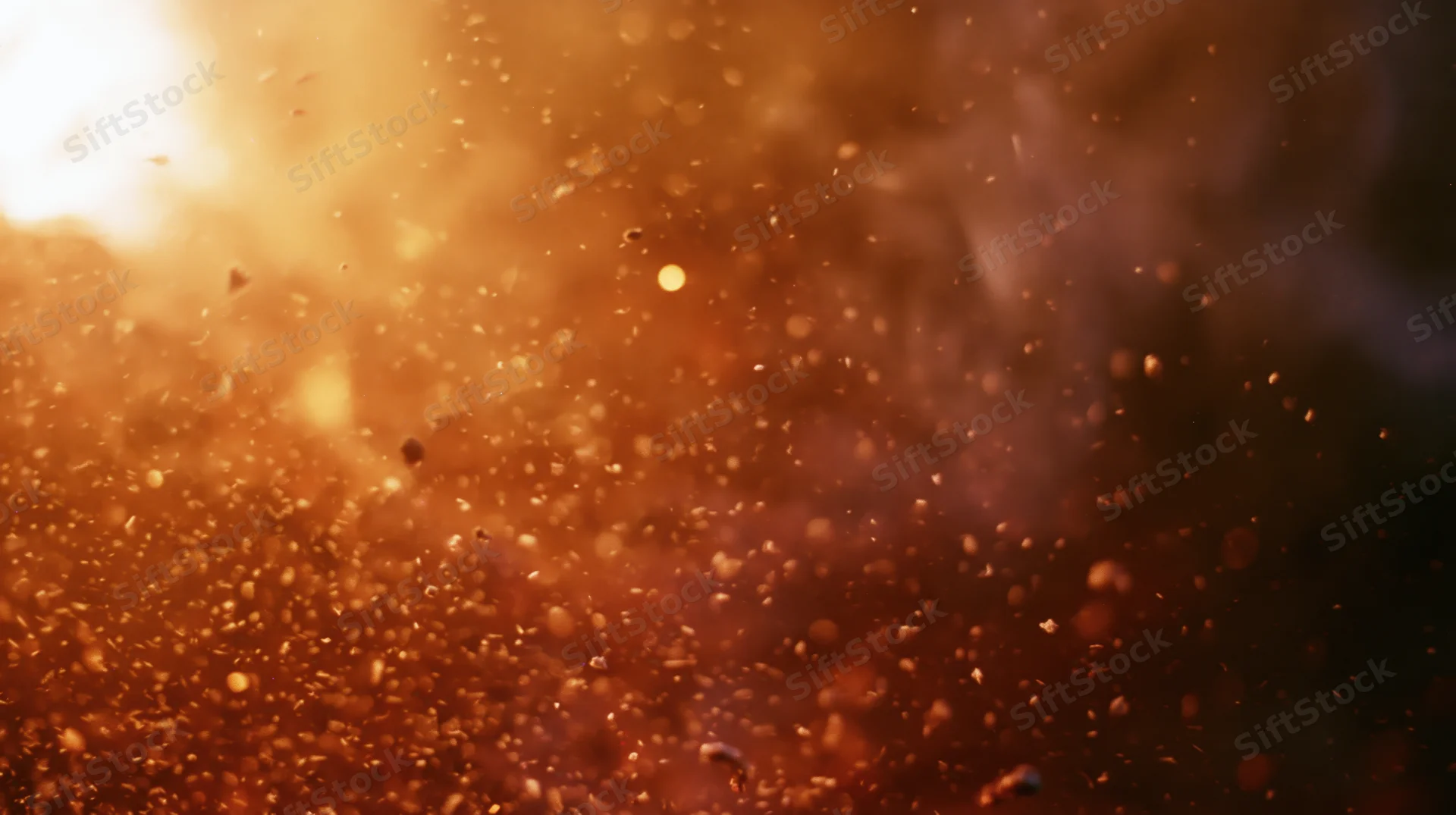 Golden light illuminating floating dust particles in warm atmospheric haze