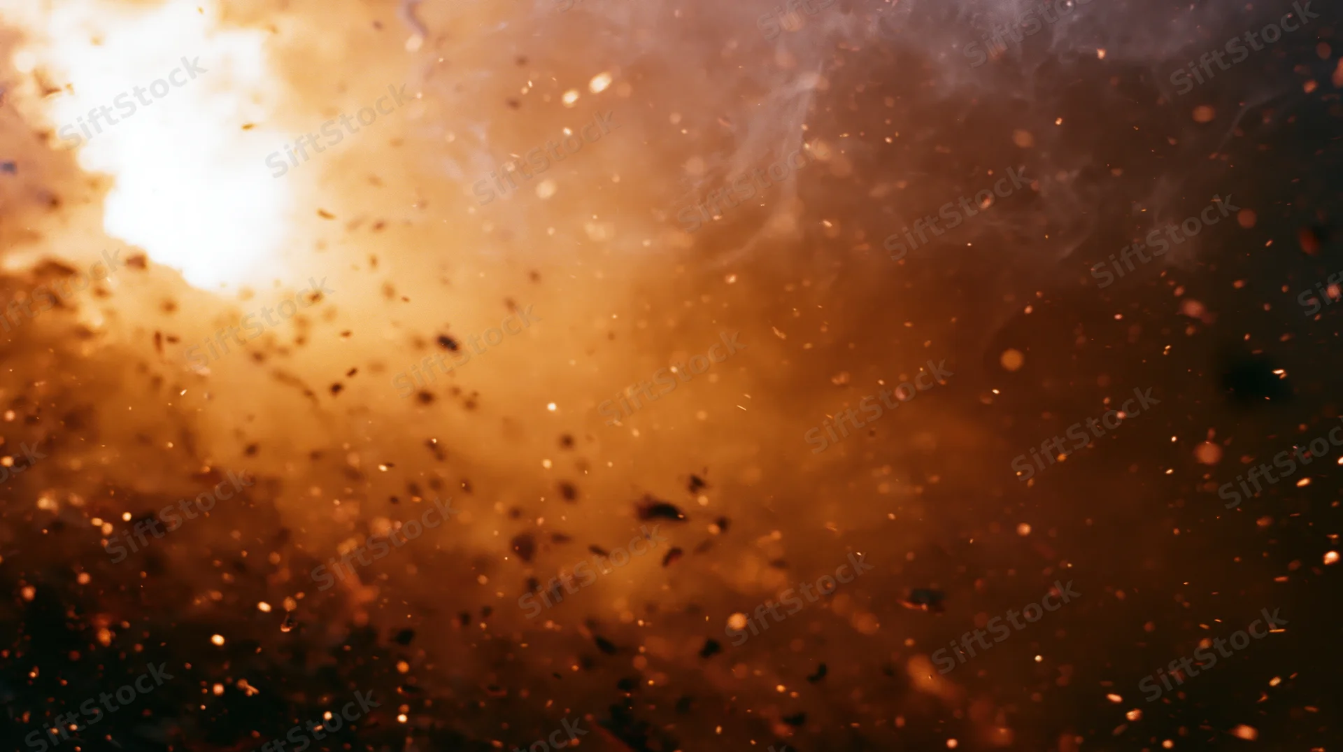 Fiery explosion with flying sparks and smoke filling the frame