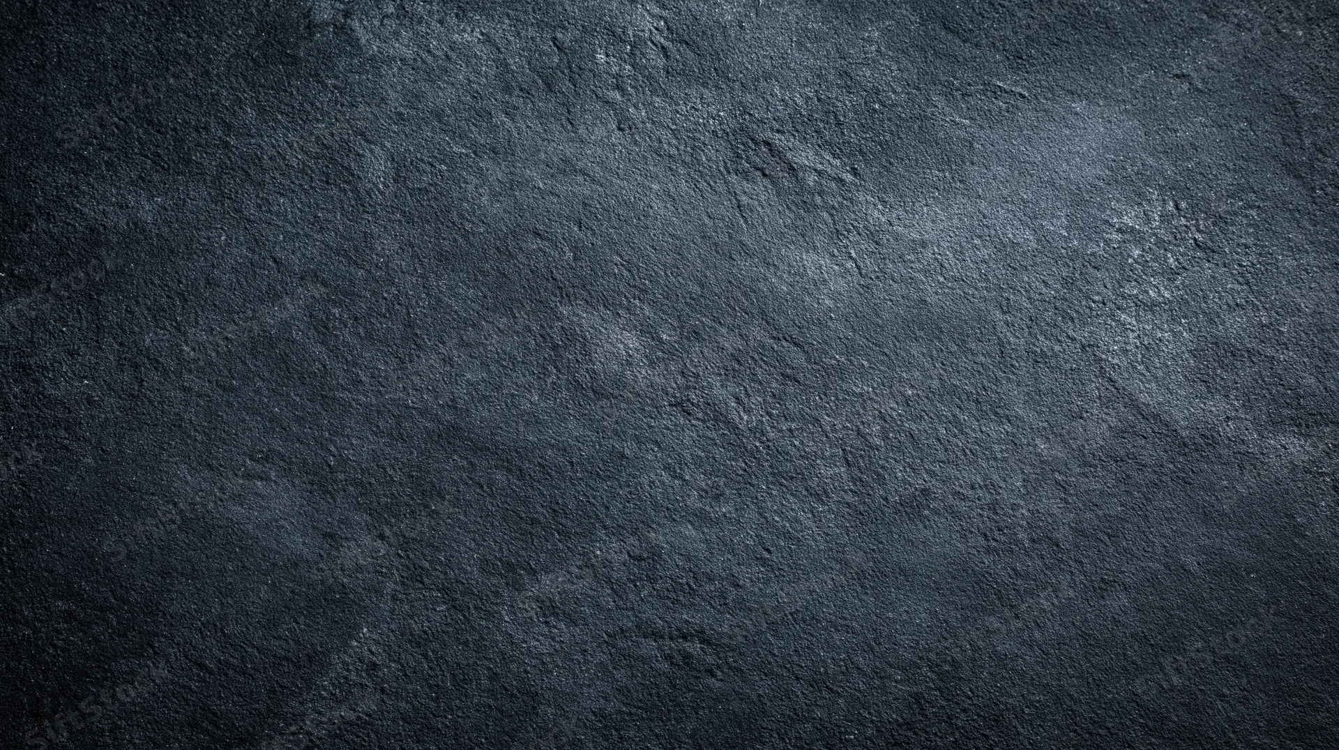 Dark textured stone surface with rough grainy finish as background