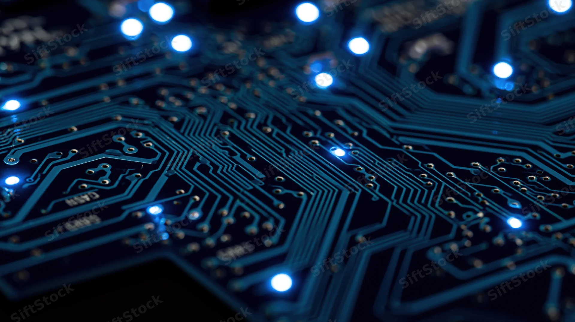 Closeup of illuminated blue circuit board with glowing leds and intricate traces
