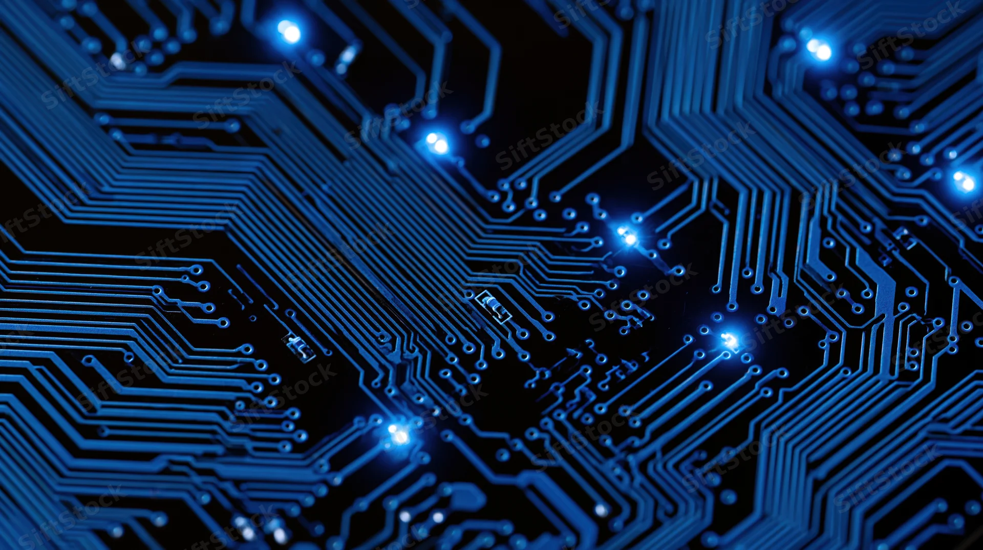 Illuminated blue circuit board with glowing connections and pathways