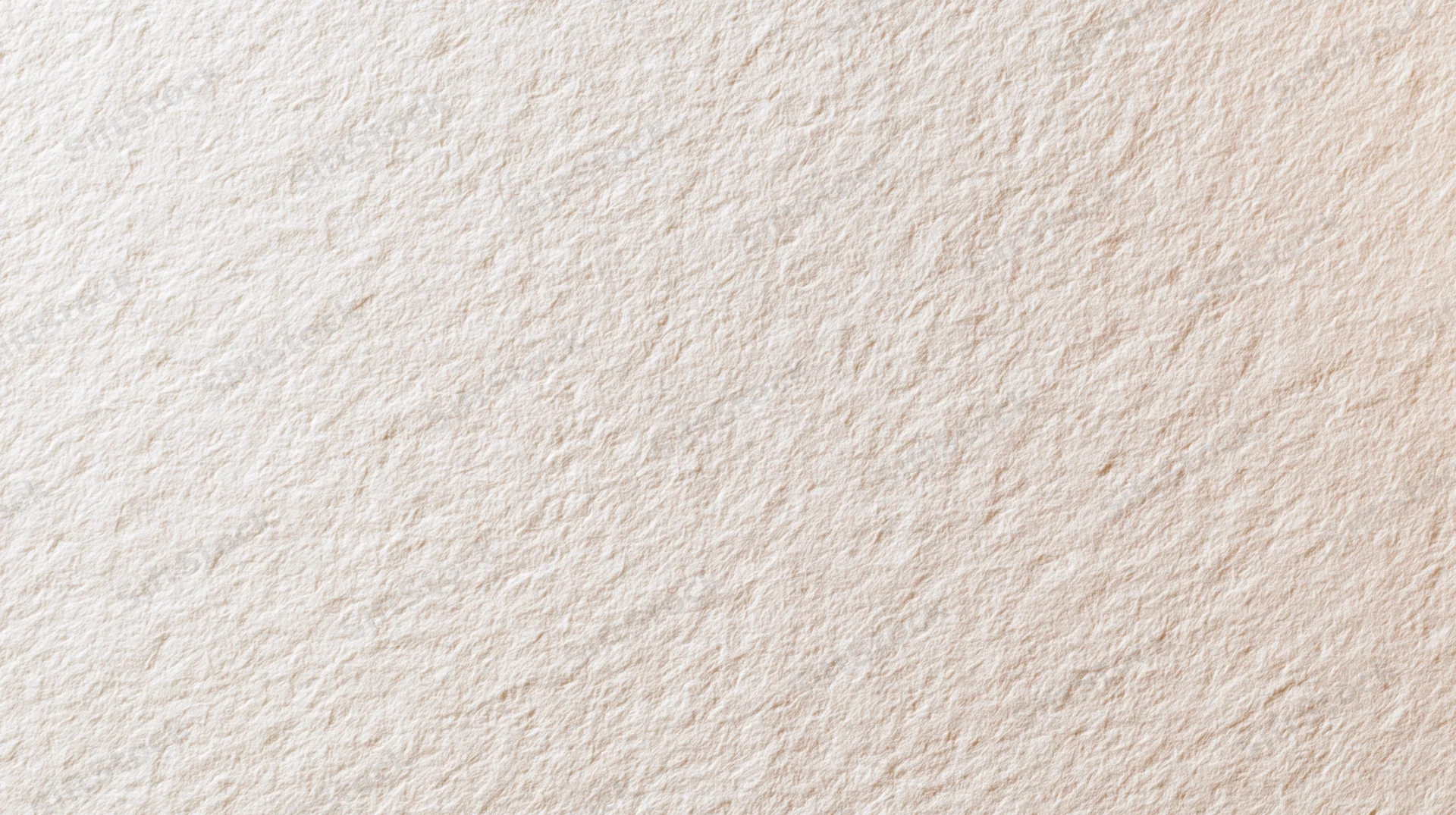 Textured beige surface filling the frame as a neutral background with subtle grain and even lighting