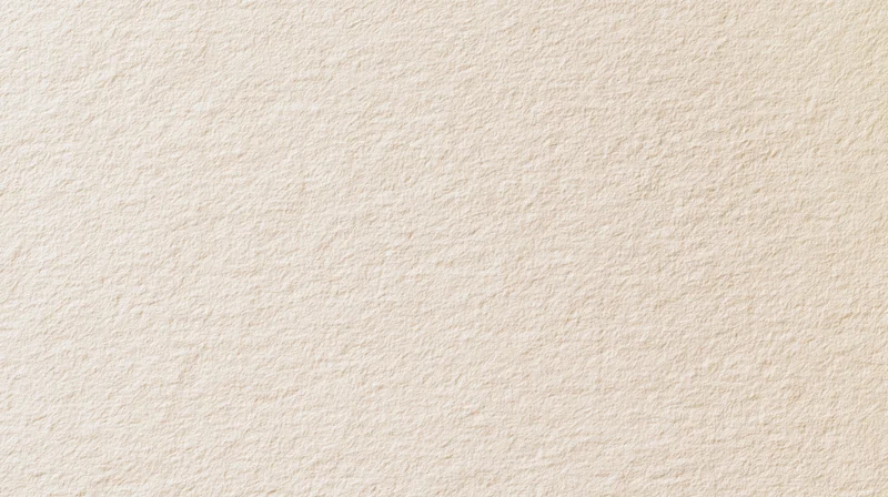 Beige textured paper surface as a neutral background with subtle grain and even tone