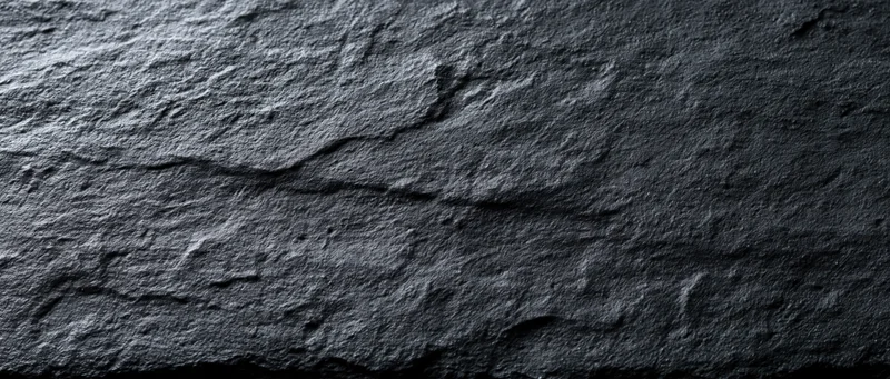 Dark textured stone surface with natural rugged pattern