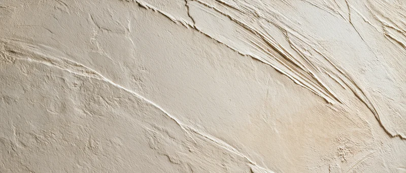 Textured plaster wall with diagonal brushstrokes and uneven surface finish