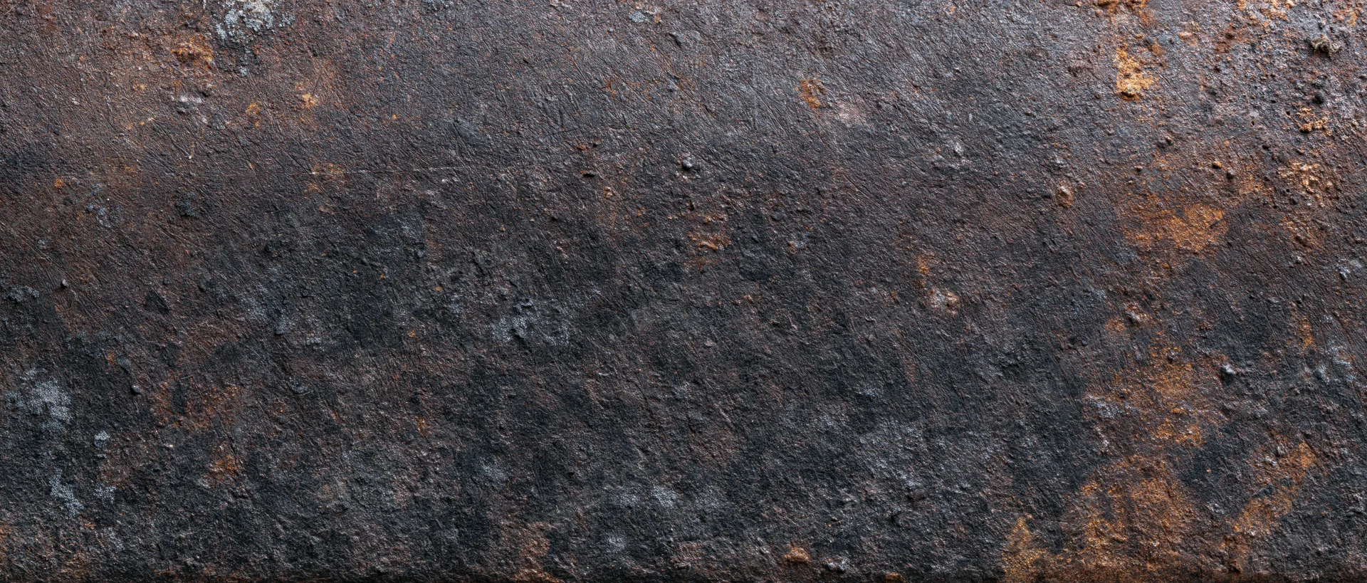 Rusted metal surface with weathered texture and oxidized patches