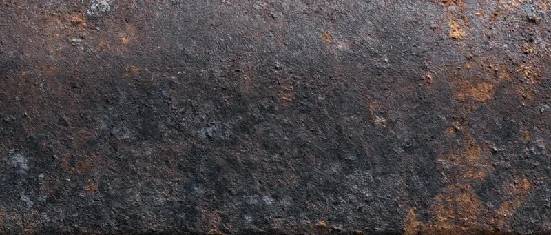 Rusted metal surface with weathered texture and oxidized patches