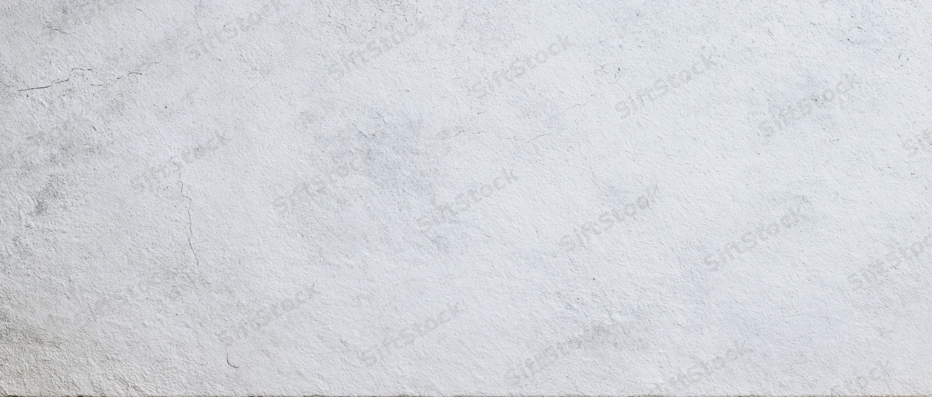 Textured concrete wall surface with cracks and weathered finish