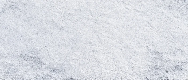 Close-up of a white textured stone wall surface