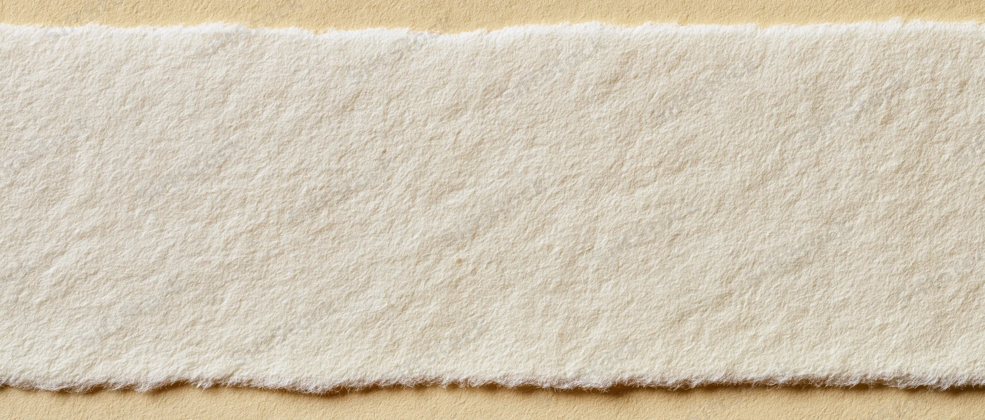 Textured wool felt strip on beige background with copyspace