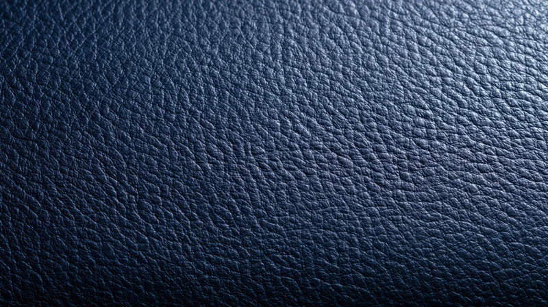 Closeup of dark blue leather texture with visible grain pattern