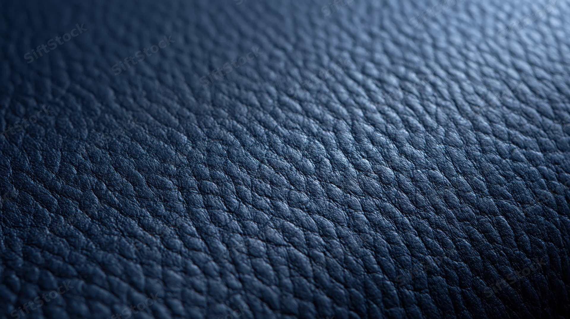 Closeup of dark blue leather texture with pebbled grain pattern