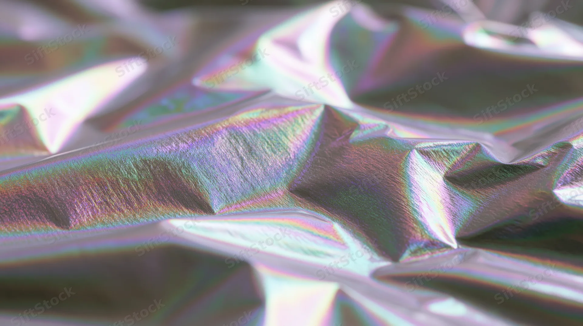 Crumpled holographic foil with iridescent rainbow reflections in closeup view