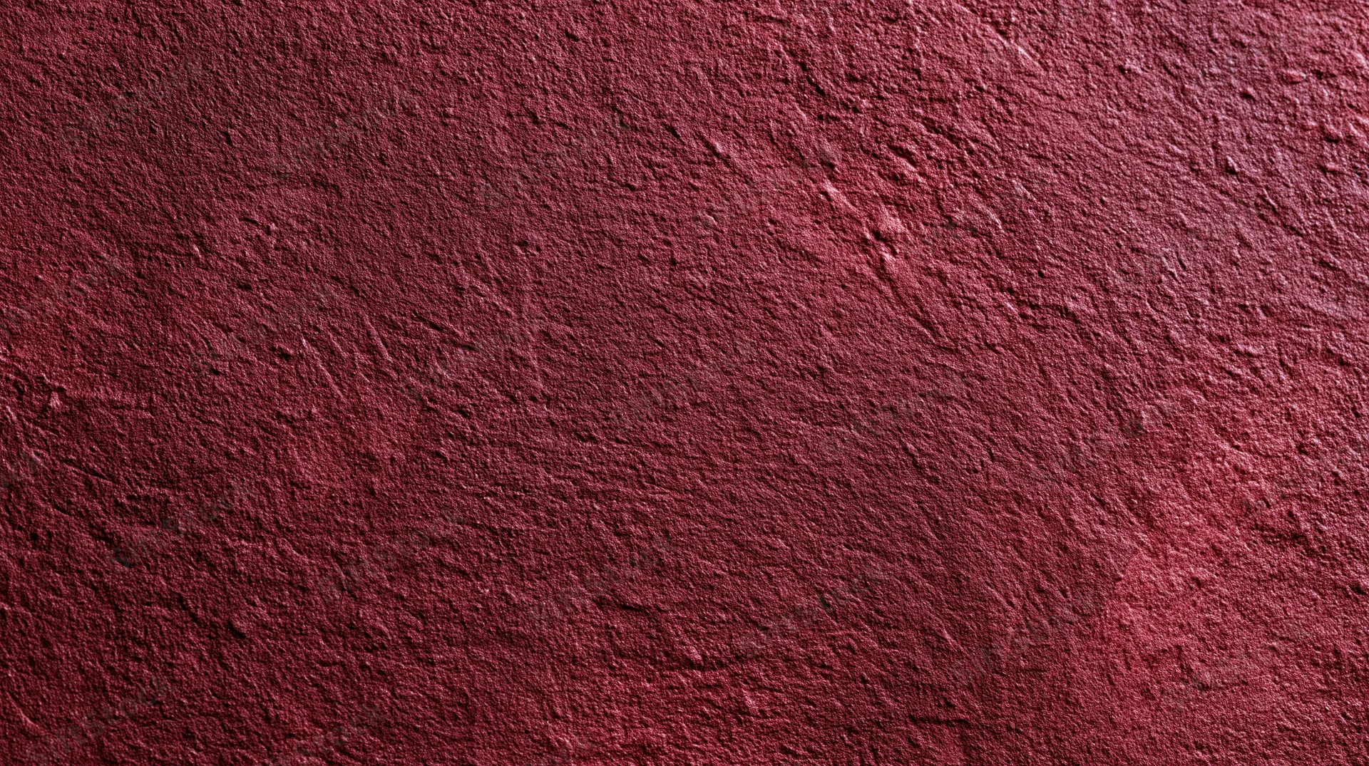 Closeup of a rough red plastered wall surface