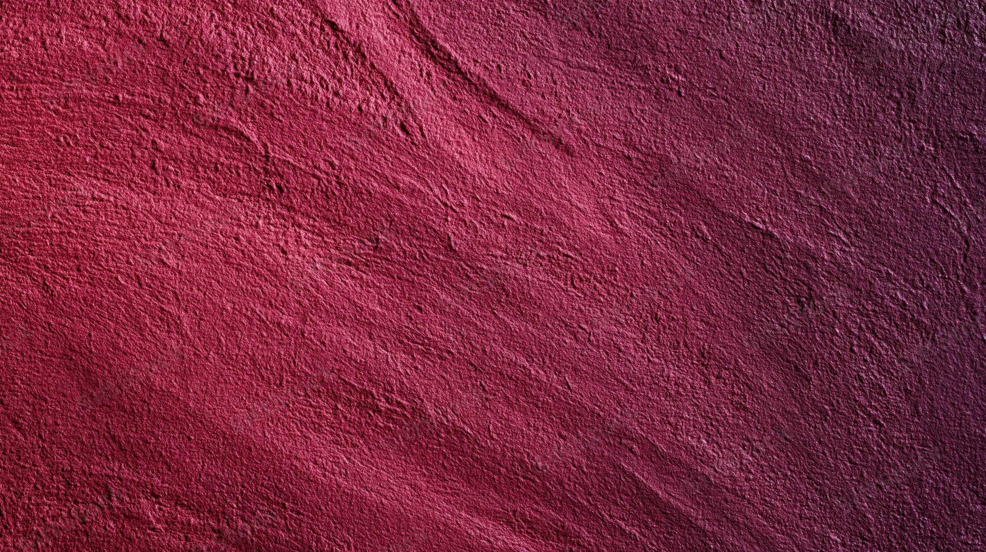 Closeup of a textured red stone surface with natural grain and uneven pattern