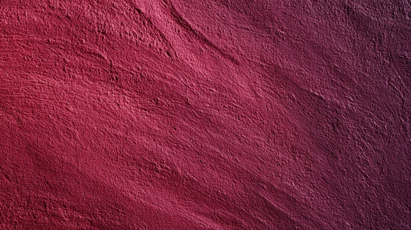 Closeup of a textured red stone surface with natural grain and uneven pattern