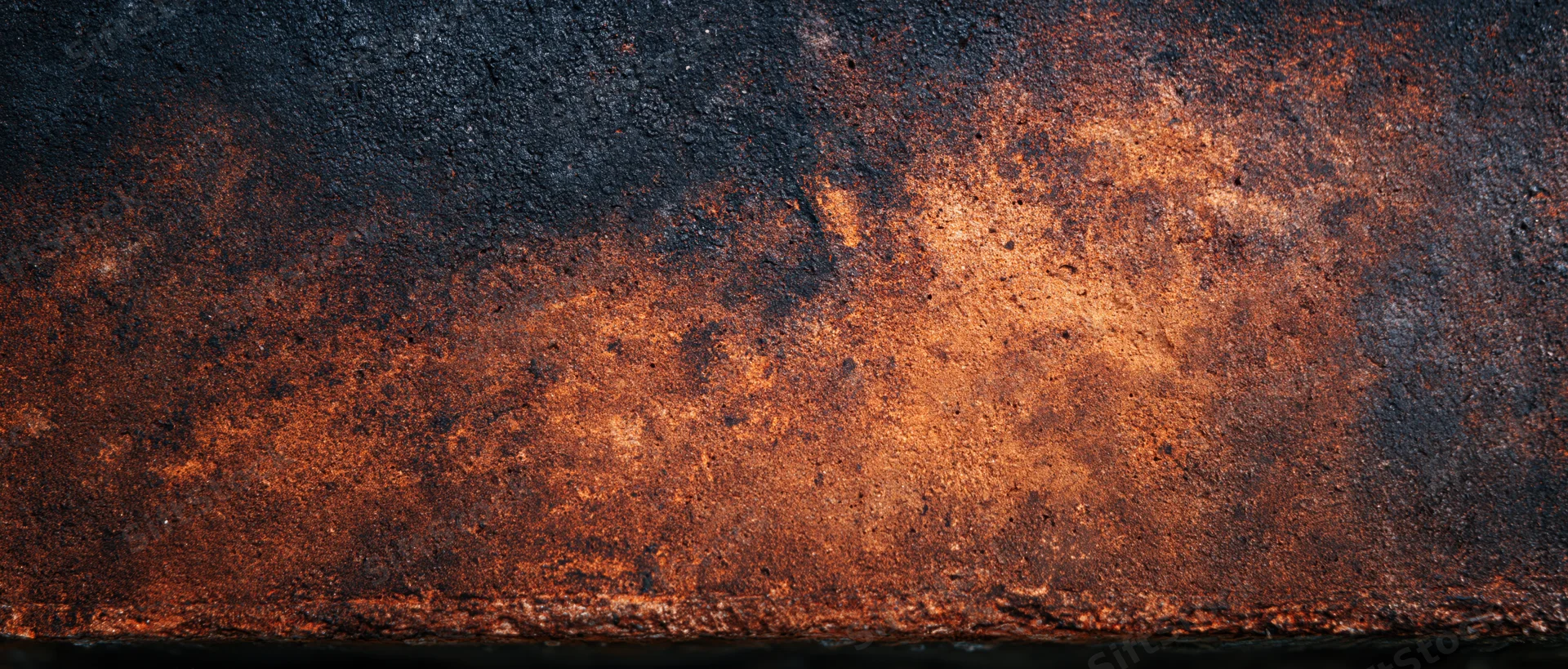 Rusted metal surface showing corrosion and weathering with dark and orange tones