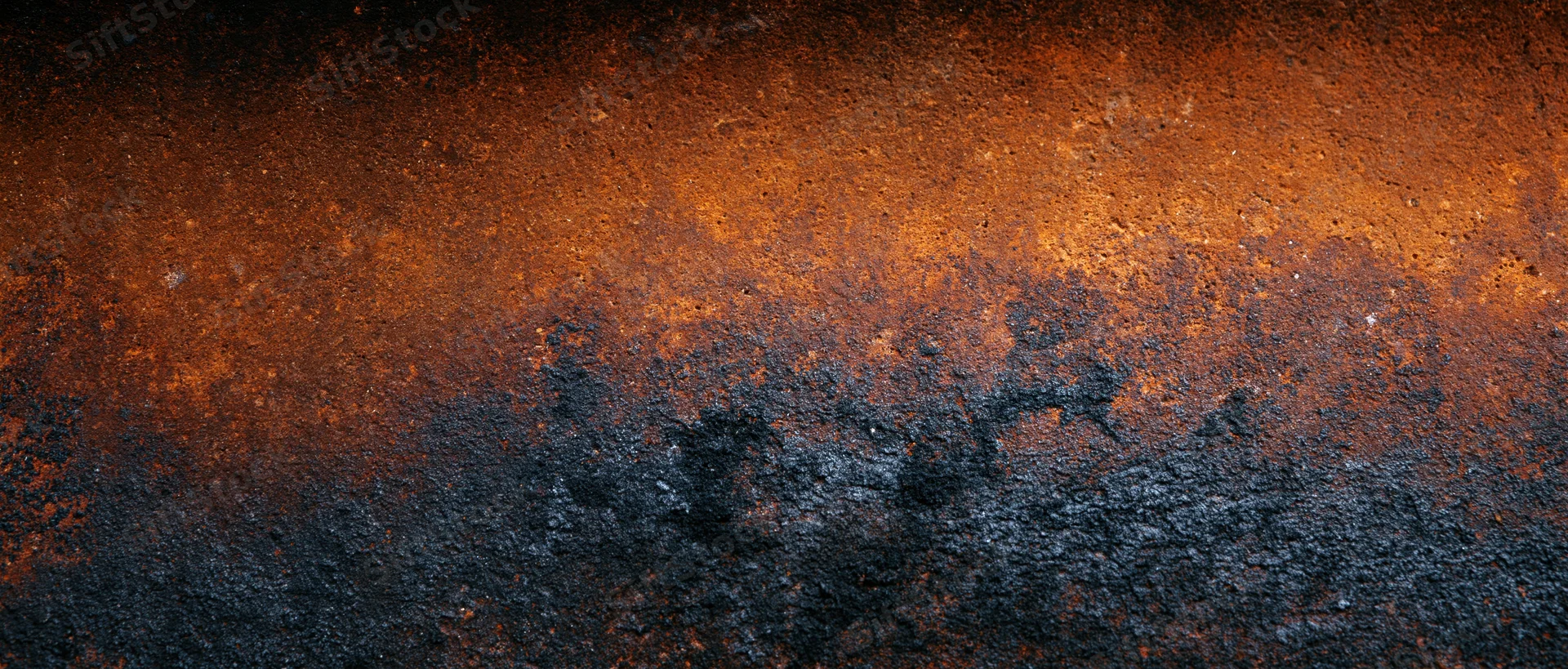 Rusted metal surface showing corrosion and weathering with orange and black tones