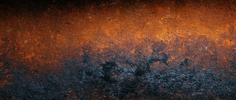 Rusted metal surface showing corrosion and weathering with orange and black tones