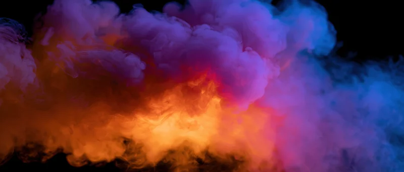 Swirling colorful smoke clouds against black background