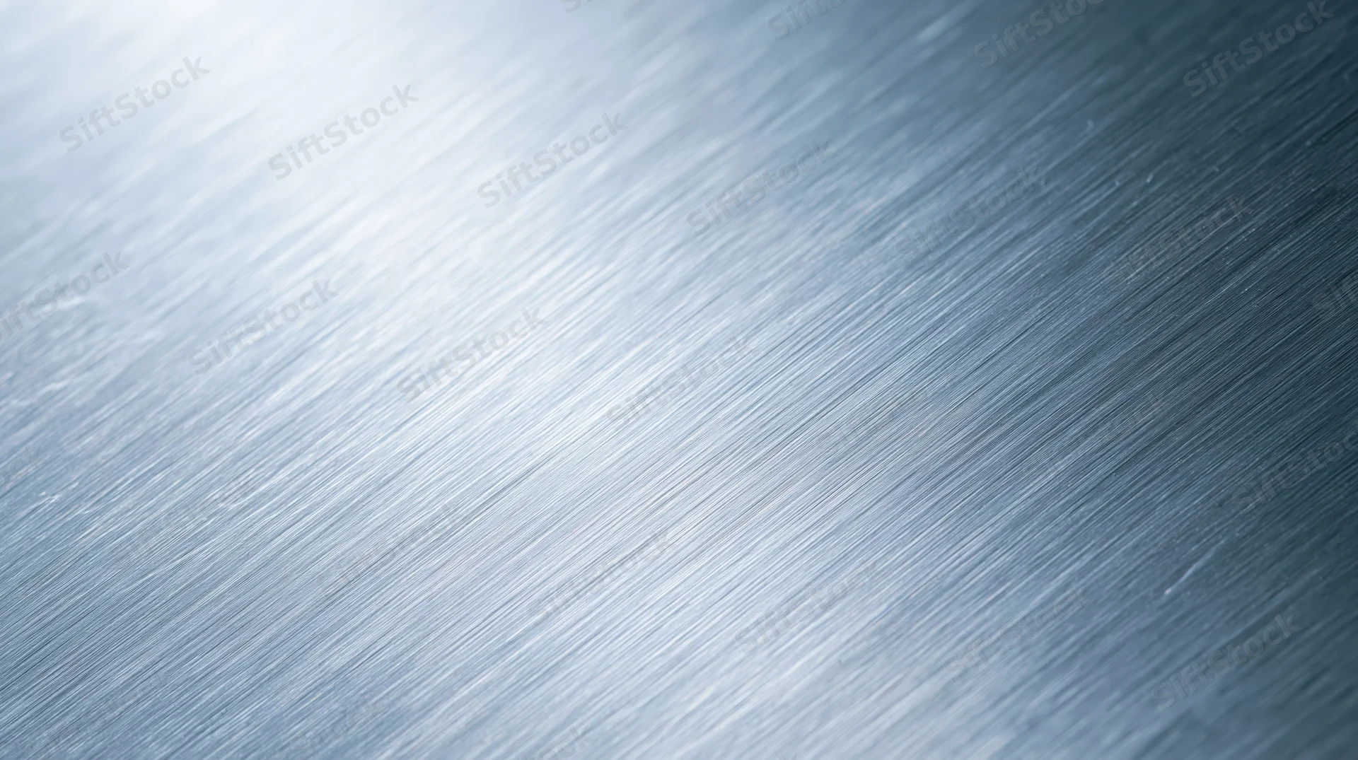 Brushed metal surface with diagonal texture and light gradient