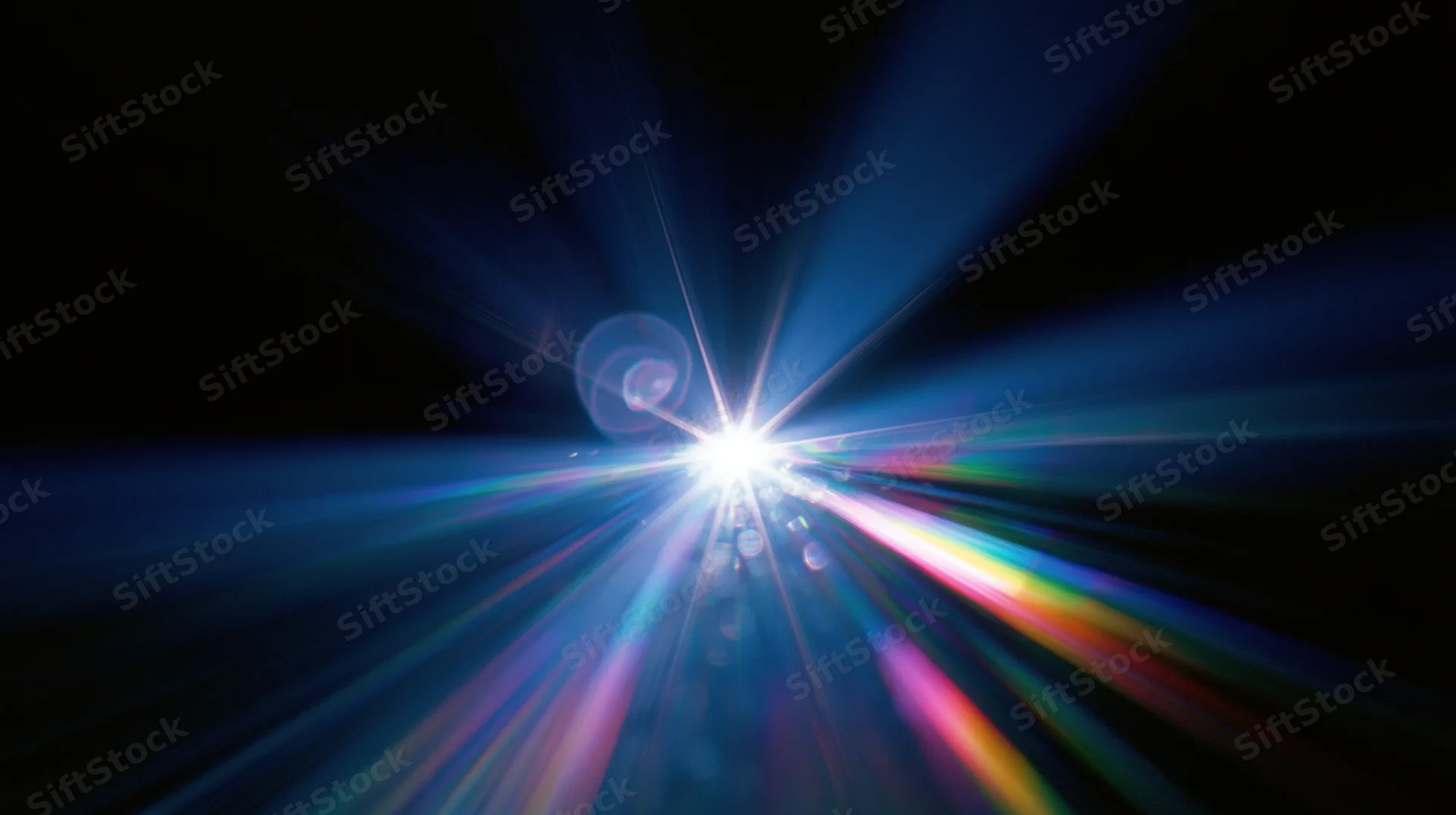 Bright light burst radiating colorful beams across dark background