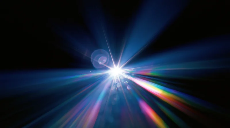 Bright light burst radiating colorful beams across dark background